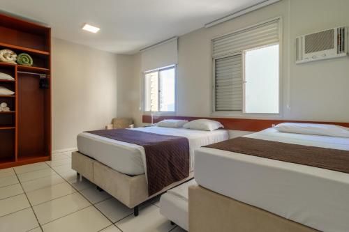 a bedroom with two beds and a window at Rio Branco Hotel in Florianópolis