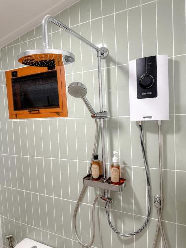 a shower in a bathroom with a toiler at Oriental VILLA TRAT ตราด in Trat