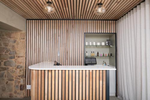 a kitchen with a counter in the middle of a room at Cradle Boutique Hotel in Lanseria