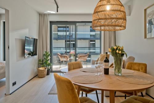 a dining room with a table and chairs at Apartamenty Wydma & Las BlueApart in Jastarnia