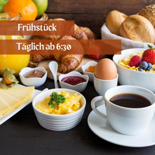 a table with breakfast foods and a cup of coffee at Hotel Lava Inn - 24 h Check-In - Nähe LKH, Landeskrankenhaus, Feldbach in Feldbach