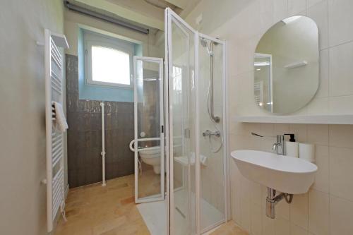 a bathroom with a shower and a sink and a mirror at Agriturismo Biancarda in Massignano