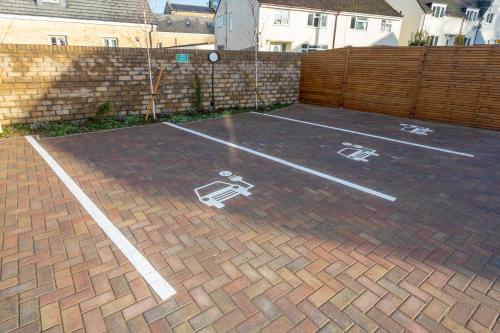 a basketball court with white markings on a brick driveway at 30 Chipping Norton - Luxury Holiday Apartments in Chipping Norton