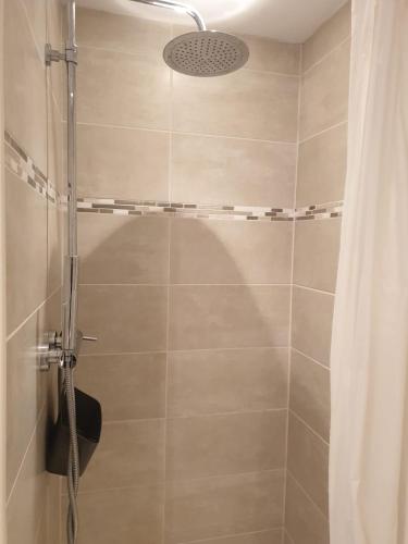 une salle de bain avec une douche avec un rideau de douche dans l'établissement Appartement climatisé à 800m de la plage, à Fréjus