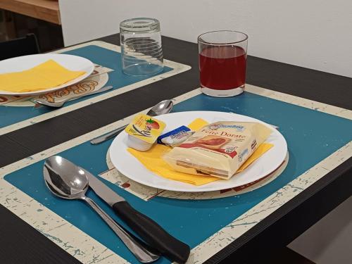 a table with a plate of food and a drink at Giardino Siciliano B&B in Catania