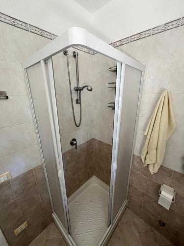 a shower with a glass door in a bathroom at Residence Verde Pineta in Principina a Mare