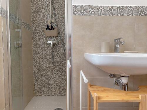 a bathroom with a sink and a shower at La Marina - Rooms In Stintino by Host Hero in Stintino