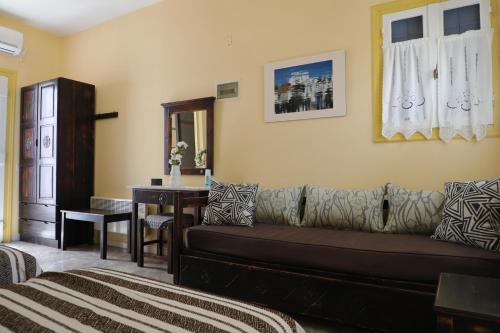 a living room with a couch and a table at Panormos Apartments in Panormos