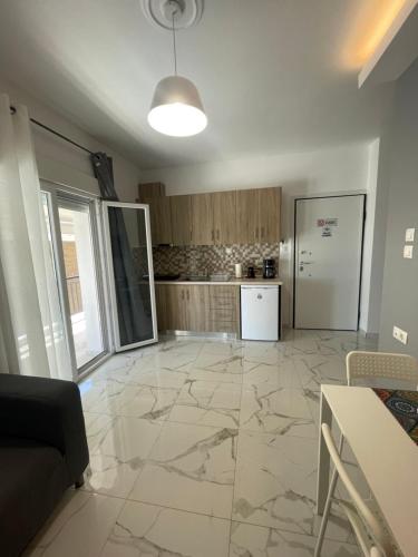 a living room with a large marble floor at Antonis apartment in Paralia Dionysiou