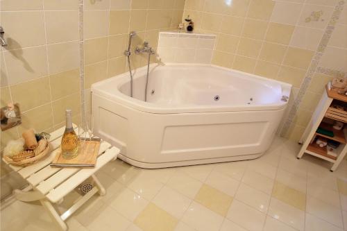 a bathroom with a large white tub in a room at Charming Chalet Rogla in Hudinja