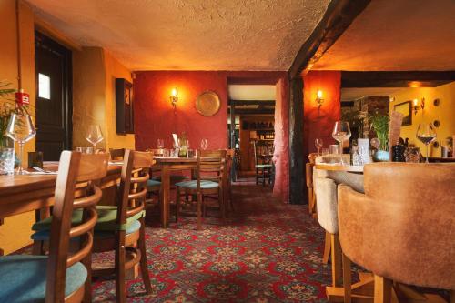 un ristorante con tavoli e sedie in legno e un bar di Blue Ball Inn a Lynmouth