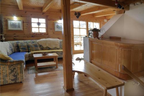 a living room with a couch and a table at Charming Chalet Rogla in Hudinja