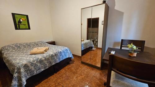 a hotel room with a bed and a mirror at Iguazu Hojas Verdes in Puerto Iguazú