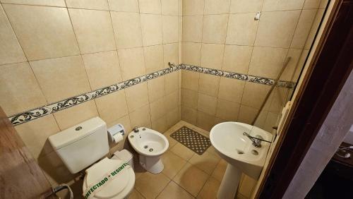 a small bathroom with a toilet and a sink at Iguazu Hojas Verdes in Puerto Iguazú
