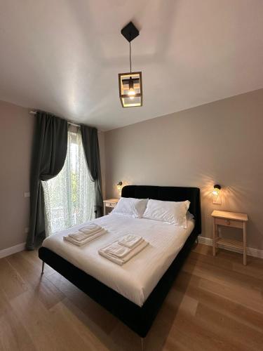a bedroom with a bed with white sheets and a window at Dimora Santa Rosalia in Alba