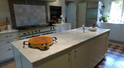 une cuisine avec un comptoir avec un bol en bois sur un îlot dans l'établissement Élégante Maison de Maître avec Piscine et Parc à Biarritz, à Biarritz