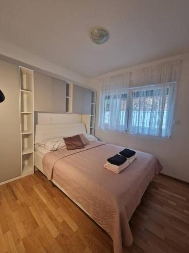 a bedroom with a large bed and a window at Apartman Emily2 Dramalj in Dramalj
