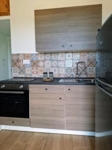 a kitchen with a sink and a stove at Granatelli Holiday Home in Altavilla Milicia
