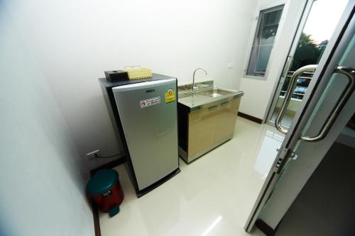 a small bathroom with a sink and a sink at Central Place Serviced Apartment in Chon Buri