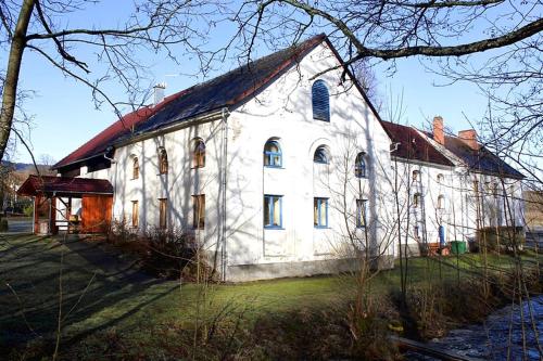 a large white building with a red roof at Penzion Jiřičná in Jiřičná