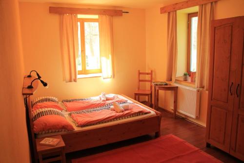 a bedroom with a bed and a window at Penzion Jiřičná in Jiřičná