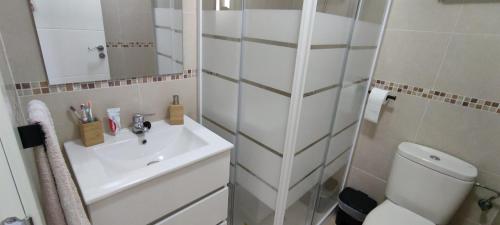 a white bathroom with a sink and a toilet at Relax & Play Panoramic Golf Vinaroz, Sant Jordi Apartment in Vinaròs