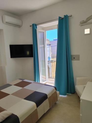 Ένα ή περισσότερα κρεβάτια σε δωμάτιο στο Kalsa’s House Noto