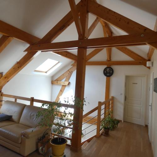 a living room with wooden beams and a couch at les iris in Villevieux