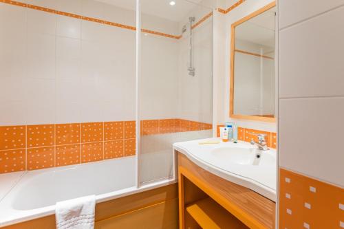 La salle de bains est pourvue d'un lavabo et d'une douche. dans l'établissement Résidence Pierre & Vacances la Corniche de la Plage, à Bénodet