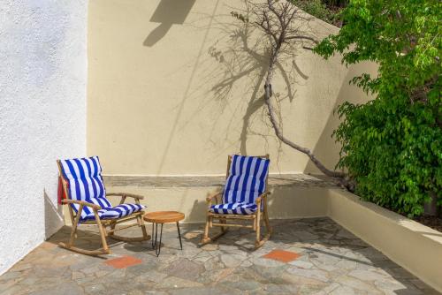 two chairs and a table sitting on a patio at Blue Horizon Apartments in Stalida