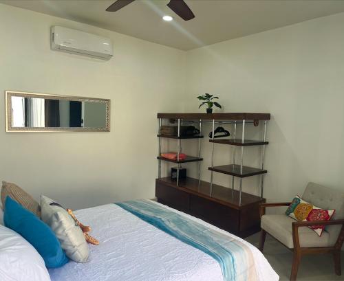 a bedroom with a bed and a dresser and a chair at Casa Amor! Completely Private Home & Pool, Close Beach, Bikes in Loreto
