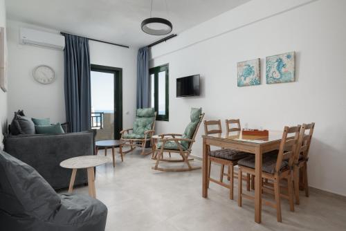 a living room with a couch and a table and chairs at Blue Horizon Apartments in Stalida