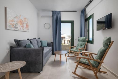 a living room with a couch and two chairs at Blue Horizon Apartments in Stalida