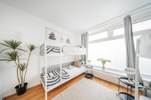 a white room with a loft bed and a window at Central Apartment Lofts in Vienna