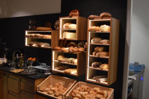 a shelf filled with lots of different types of bread at Business Motel Feldkirch in Feldkirch