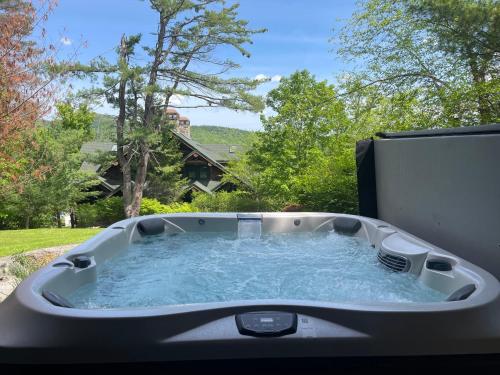 a jacuzzi tub with water in a yard at Cayuga Lodge South in Cooperstown