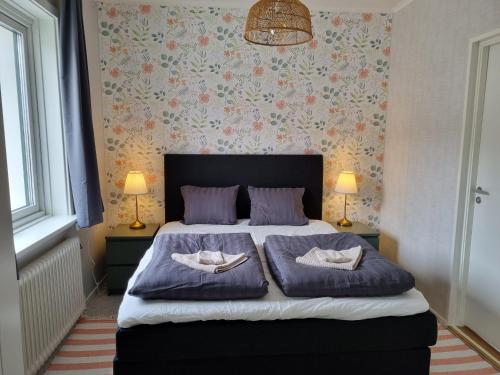 a bedroom with a bed with two pillows on it at Skulebergets Frestelse in Docksta