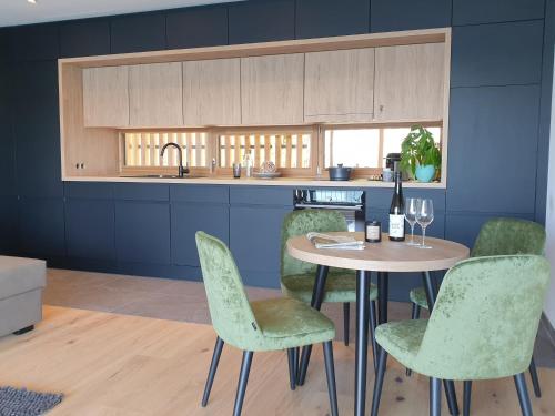 a kitchen with a table with chairs and a sink at Seehaus am Kochelsee in Kochel