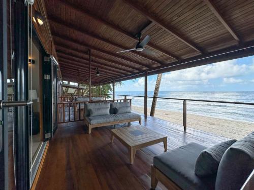 a living room with a view of the ocean at Mt. Plaisir Estate Hotel in Grande Riviere