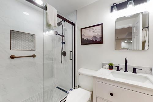 a bathroom with a shower and a toilet and a sink at Citadel 3728 in Sugar Mountain