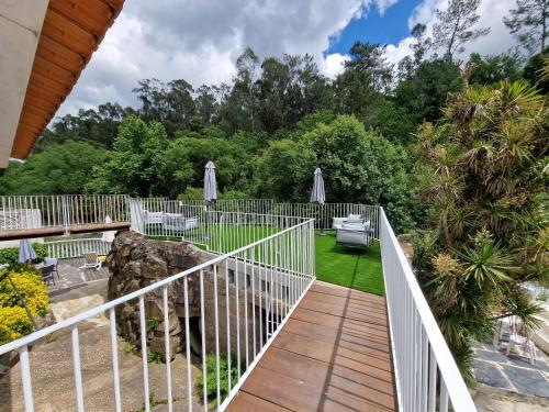 a wooden walkway leading to a garden with trees at Dream corner by waterfalls, 20 min to Oporto, by Porto with Love LDA in Parada