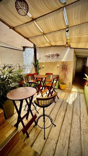 a patio with tables and chairs under awning at Rio Deal Guest House in Rio de Janeiro