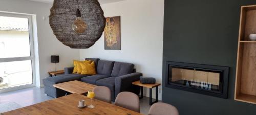a living room with a blue couch and a table at Seabreeze Luxury Apartments in Njivice