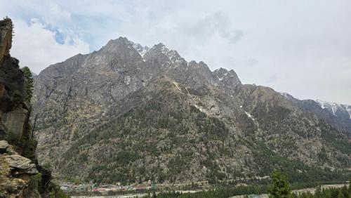 a mountain range with a town in front of it at Sangla Valley Camping in Saturang