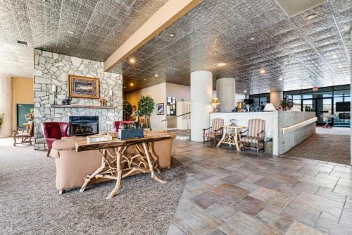 a lobby of a hotel with a stone fireplace at Highland Holiday in Sugar Mountain