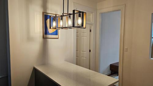 a kitchen with a table and a chandelier at Lamartine Chelsea in New York