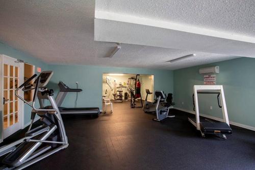 a gym with several treadmills and machines in a room at SeaBliss, oceanfront 1st floor cozy condo in Daytona Beach