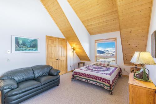 a bedroom with a couch and a bed in a room at Above the Clouds in Creede