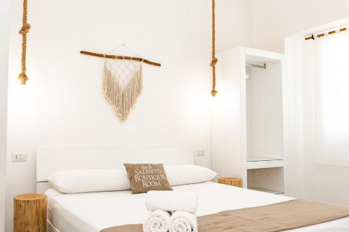 a white bedroom with a bed and a net at Salento Boutique Room B&B in Sant'Isidoro