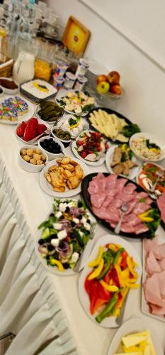 a table with many plates of food on it at Prima in Puławy